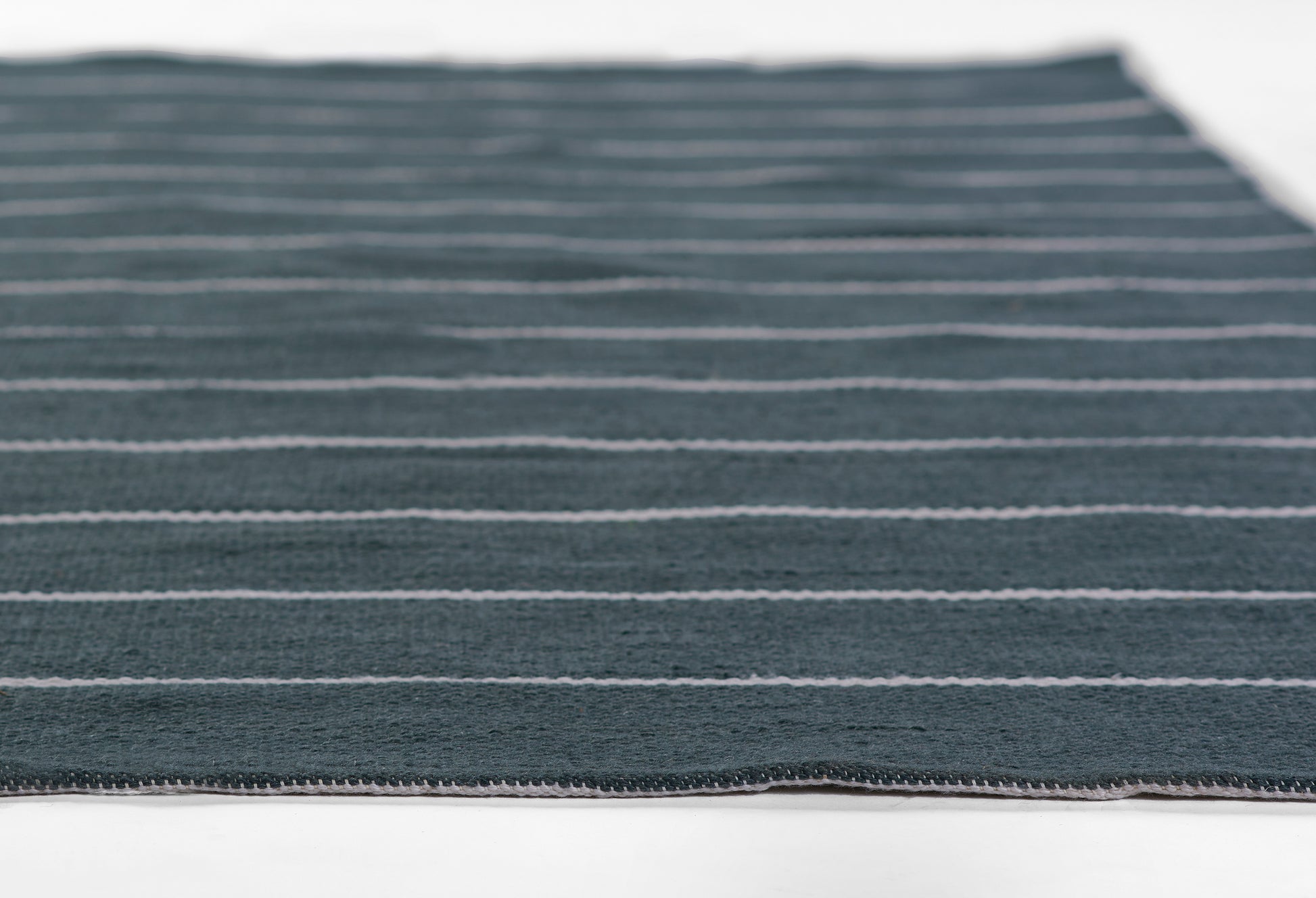 Dark blue rug with light gray horizontal stripes; woven texture, 9' x 12'.