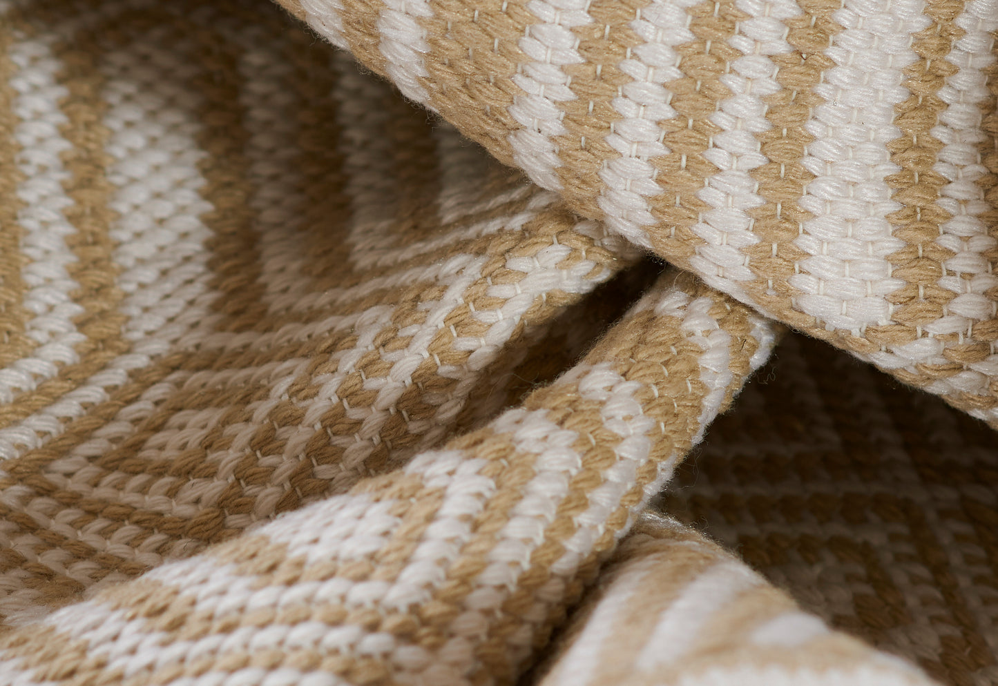 Beige and cream geometric woven rug with diamond pattern and chunky texture.