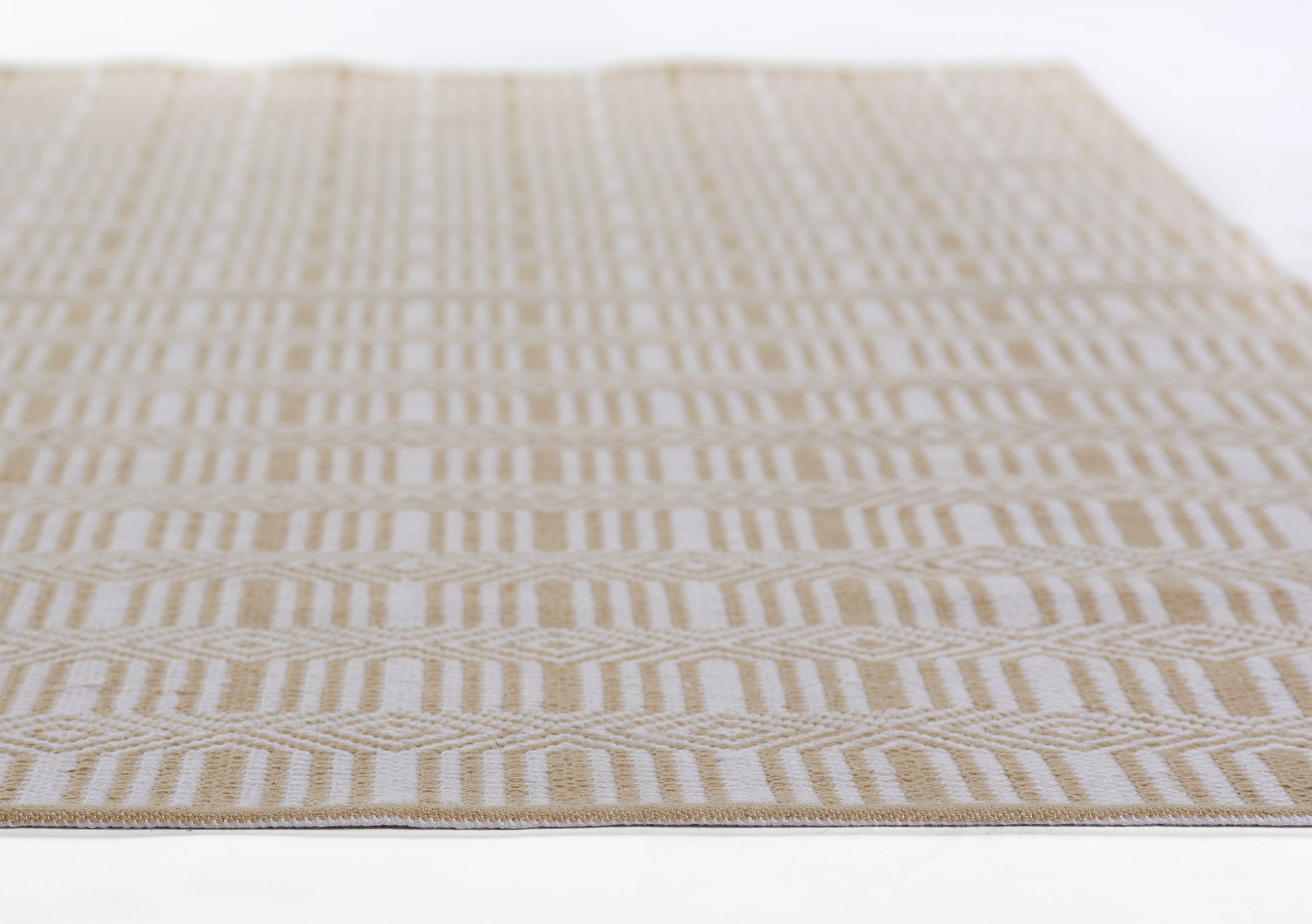 Beige and cream flat-weave rug with repeating geometric chevron stripes; rectangular natural-style home decor.