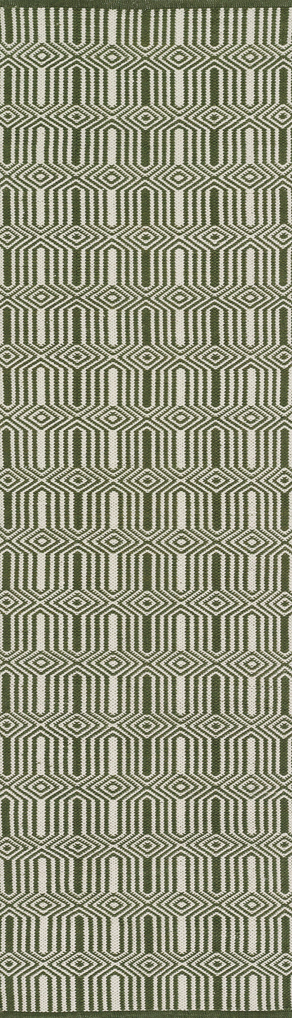Olive green woven rug with cream geometric diamond/hex pattern.