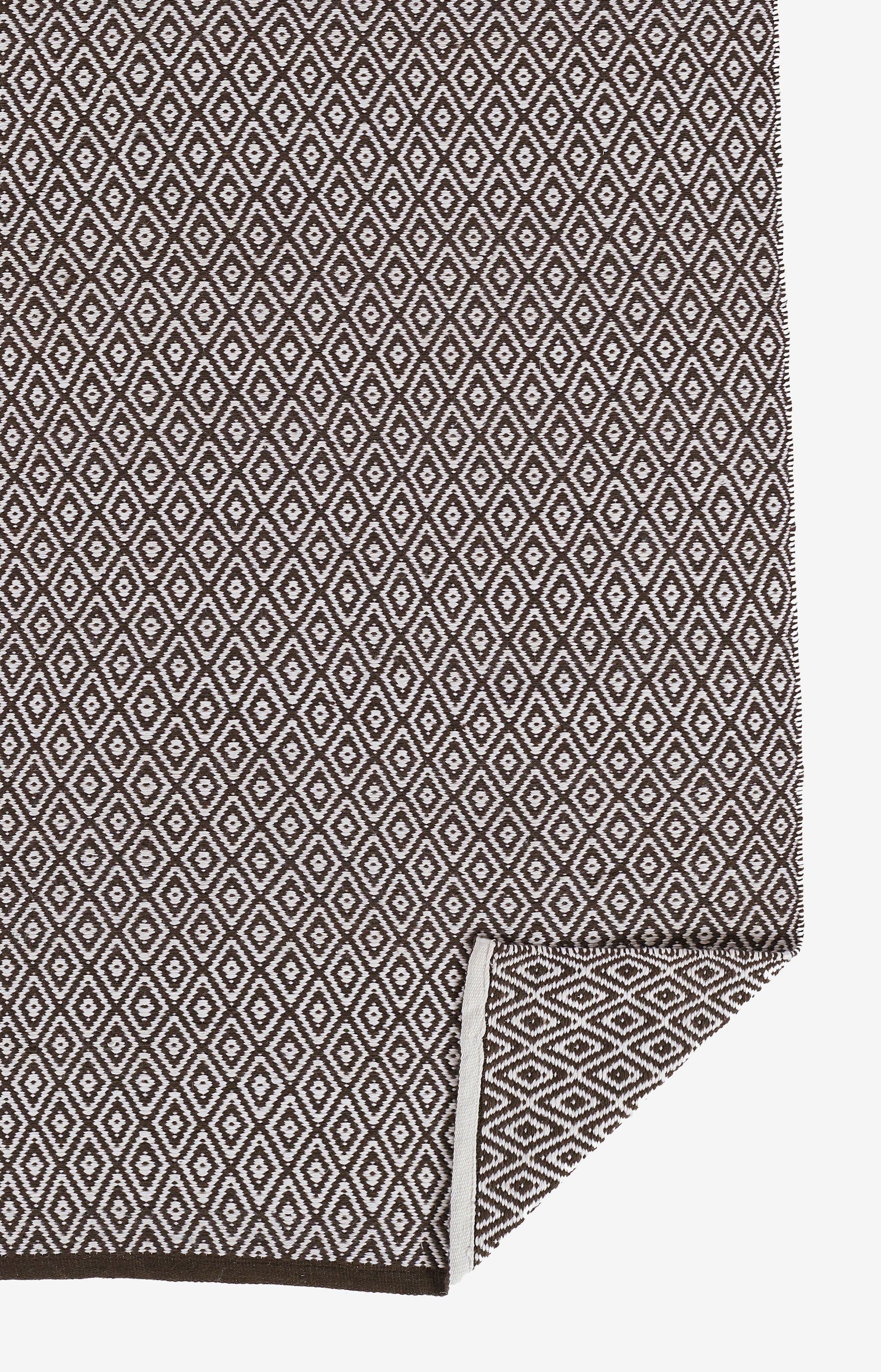 Brown and cream diamond lattice woven rug, rectangular with folded corner, 2' x 3'.