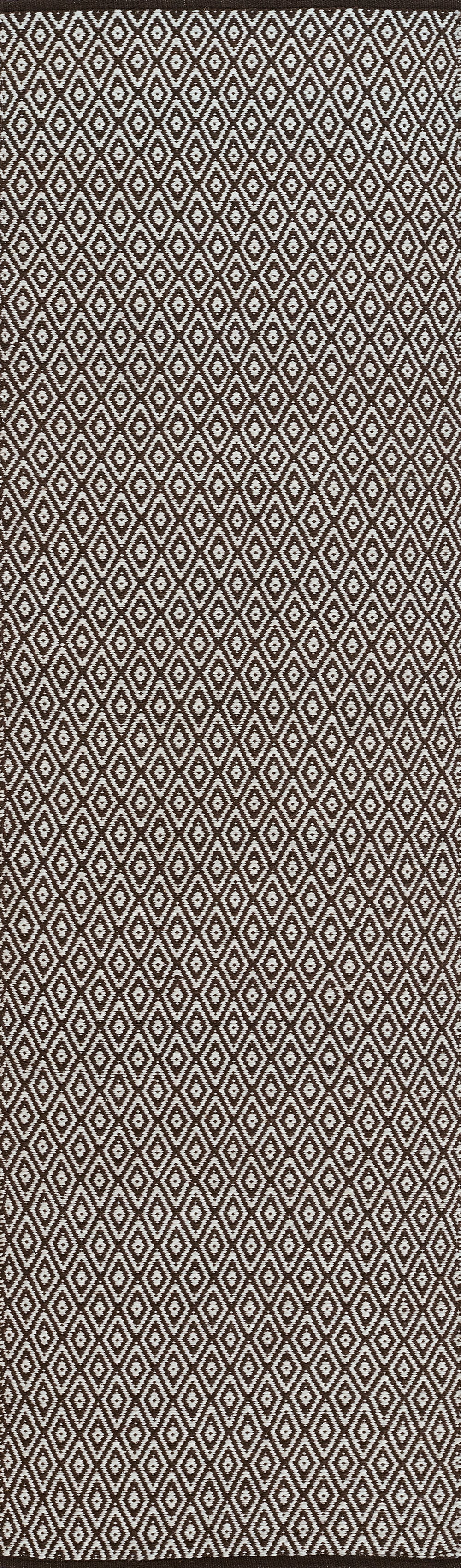 Brown woven jacquard rug with a repeating white diamond pattern; geometric motif. 2' x 3'.