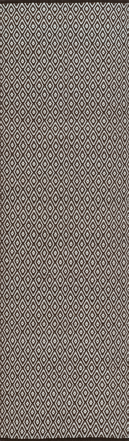 Brown woven jacquard rug with a repeating white diamond pattern; geometric motif. 2' x 3'.