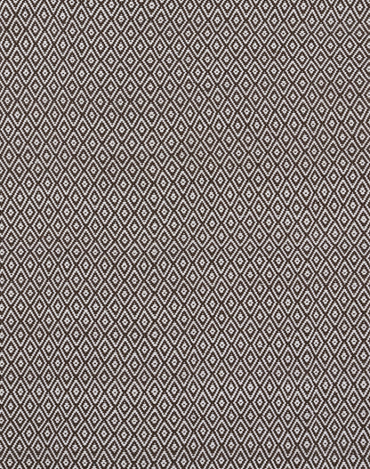 Brown and ivory diamond lattice patterned rug; woven texture.
