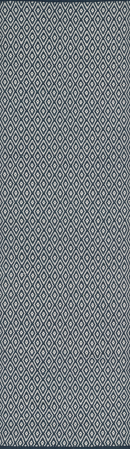 Navy rug with a repeating white diamond lattice pattern; 4' x 6'.