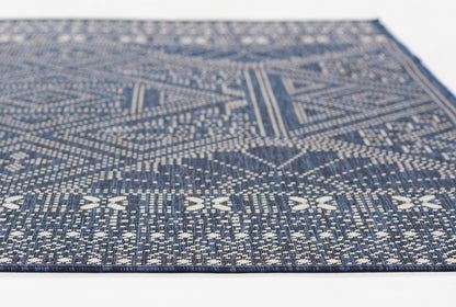 Blue & ivory geometric woven rug with tribal patterns, flat-weave, rectangular, ideal for living room or hallway.
