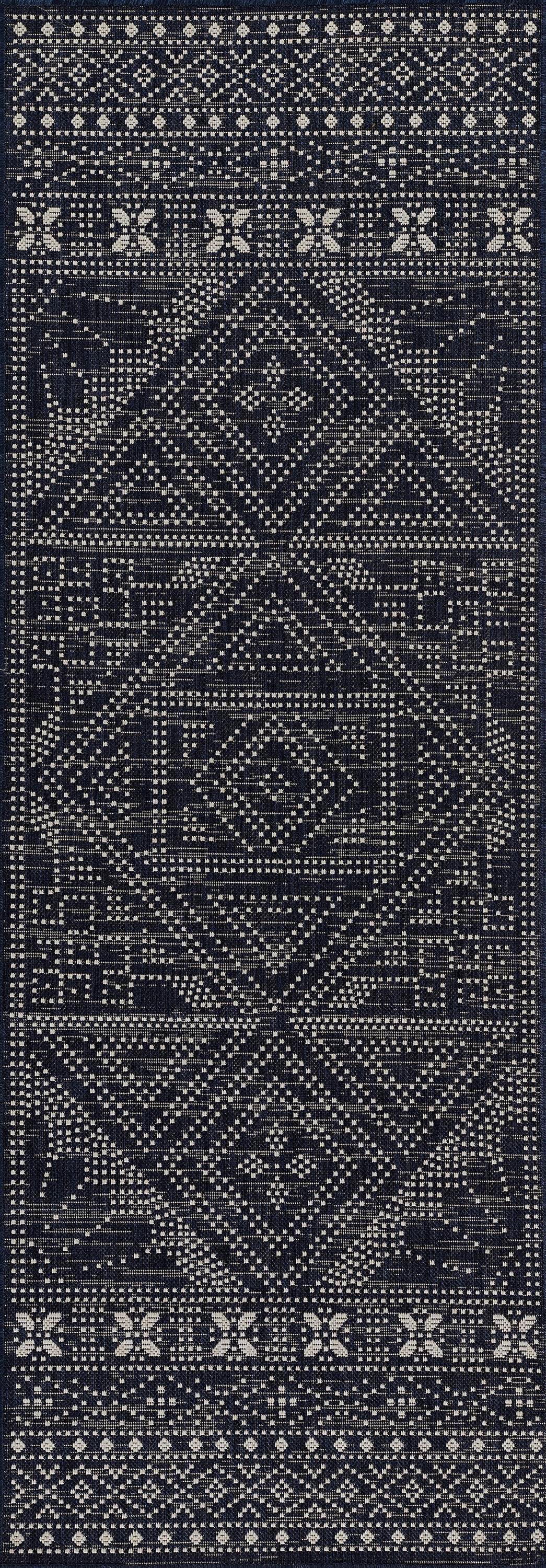 Navy blue kilim-style area rug with white geometric diamonds and border motifs; woven textile; size 5' x 7'.