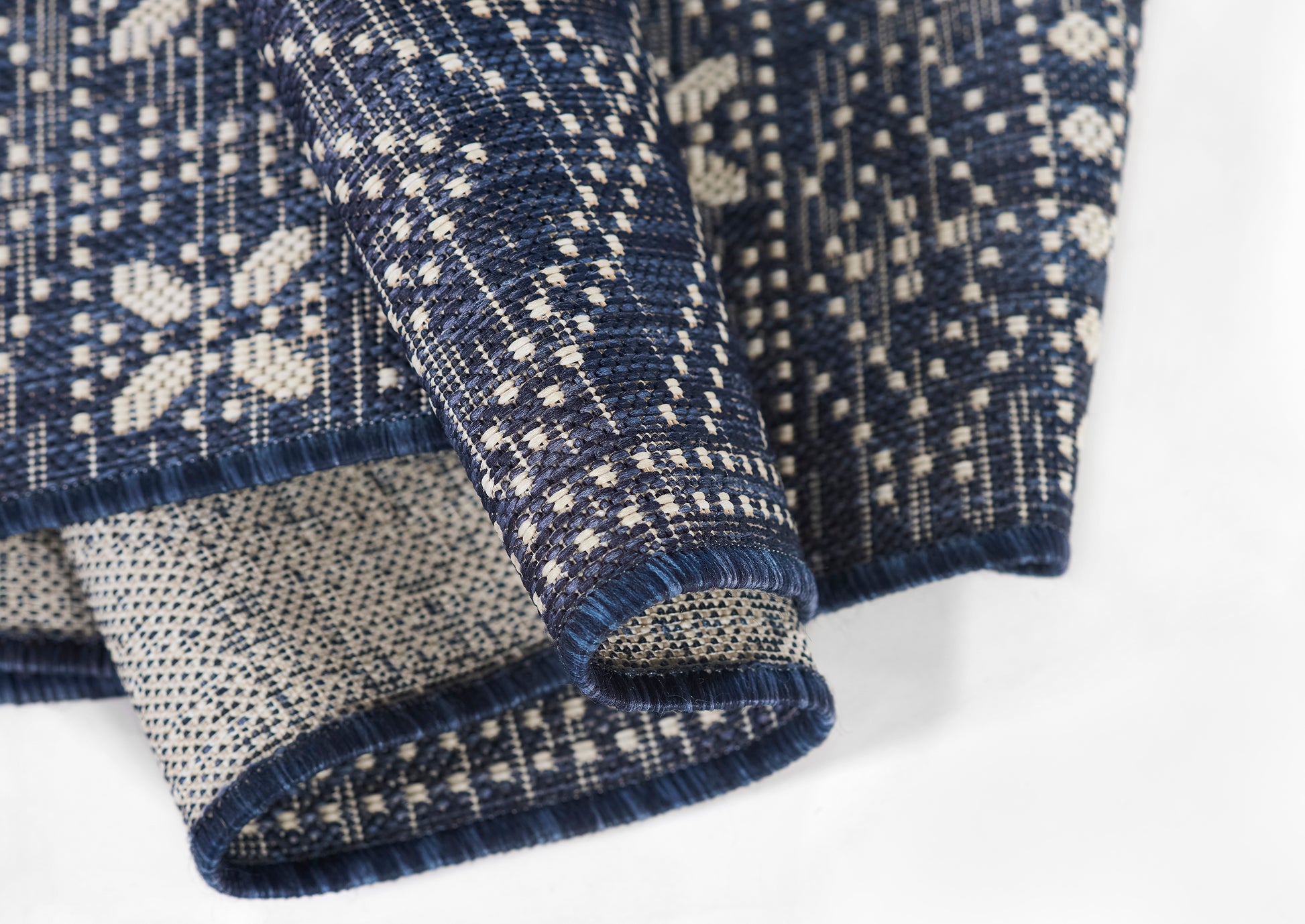 Navy knit sweater with white Nordic snowflake pattern, ribbed cuffs & hem, cozy Nordic-inspired style.
