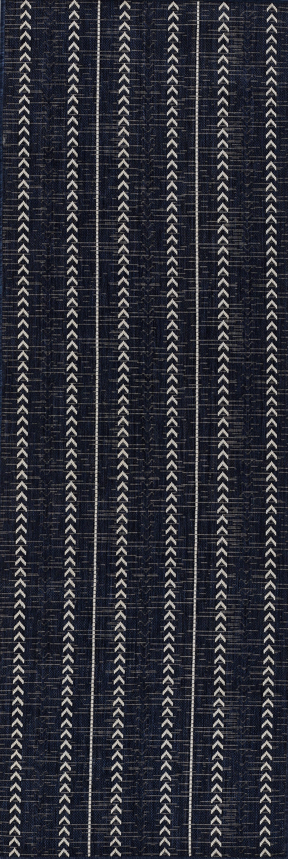Navy rug with vertical white chevron leaf pattern.