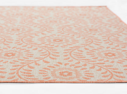 Peach floral patterned area rug with medallion motifs on ivory background; rectangular, soft woven texture.