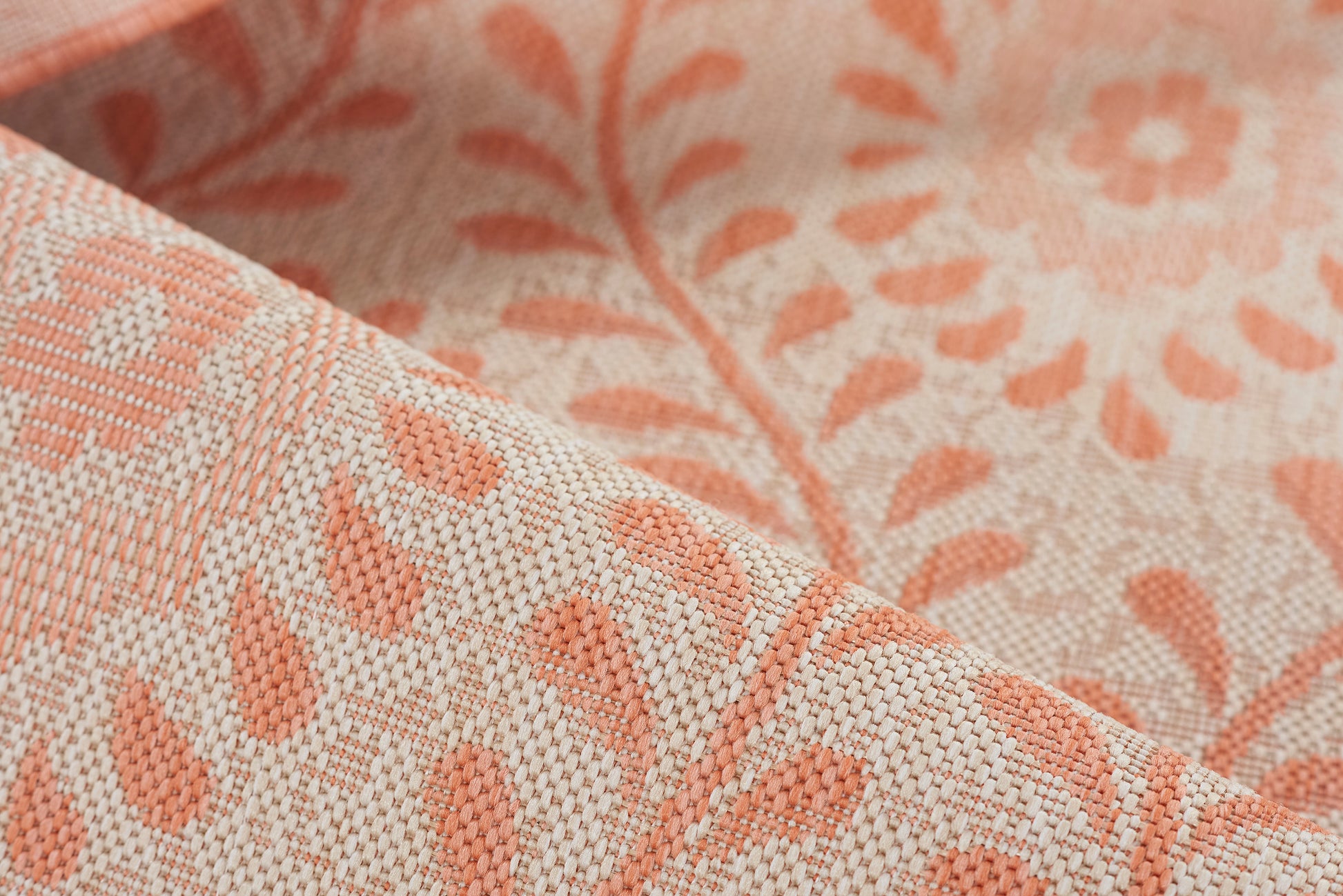 Peach & cream jacquard rug with botanical leaf damask pattern and textured weave.