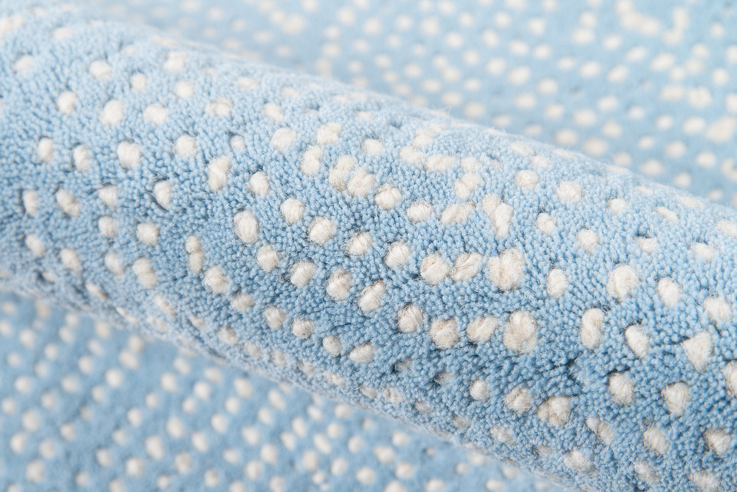 Light-blue runner rug with white raised dots; plush dotted texture.