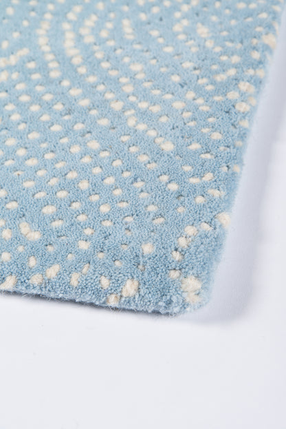 Light blue plush rug with white dotted swirl pattern, soft microfiber pile, rectangular living room rug.