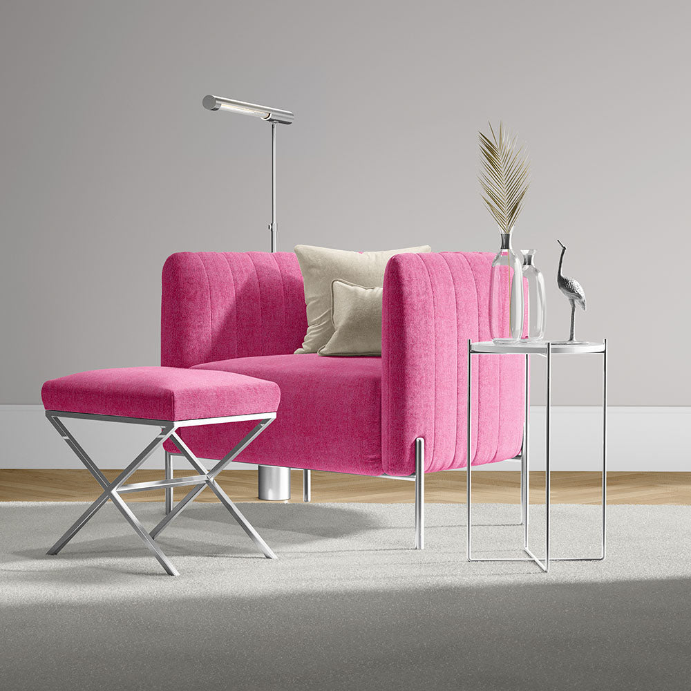 Hot pink solid fabric lounge chair with matching ottoman, chrome legs, beige cushions, side tables in a modern living room.