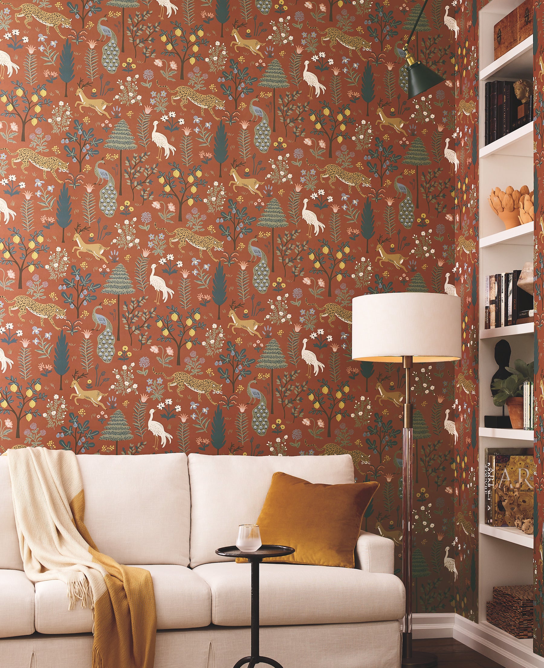 Brown wallpaper with a wildlife floral pattern featuring trees, flowers, birds and leopards.