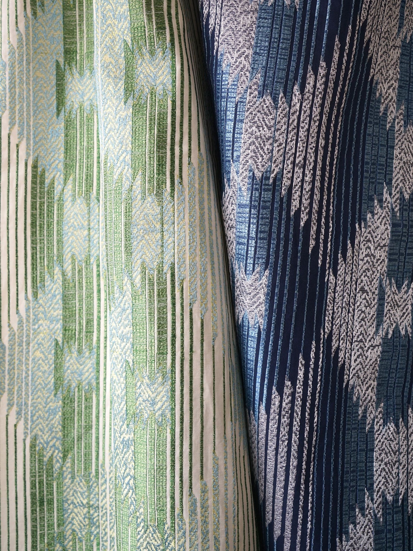 Two-tone woven blanket fabric with vertical chevrons; green & light blue left, navy & light blue right; textured jacquard.