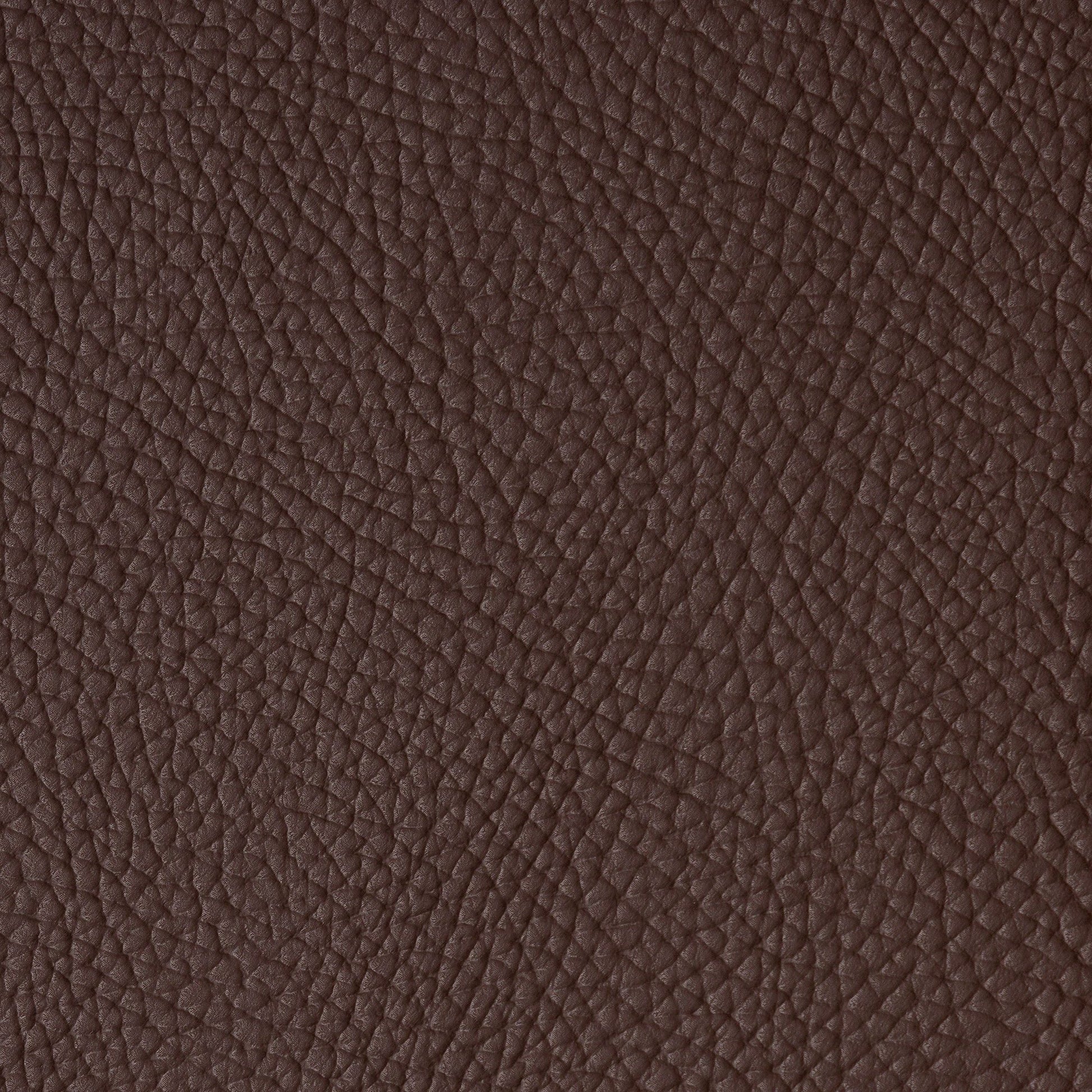 Close-up of dark brown vegan leather with pebbled grain.