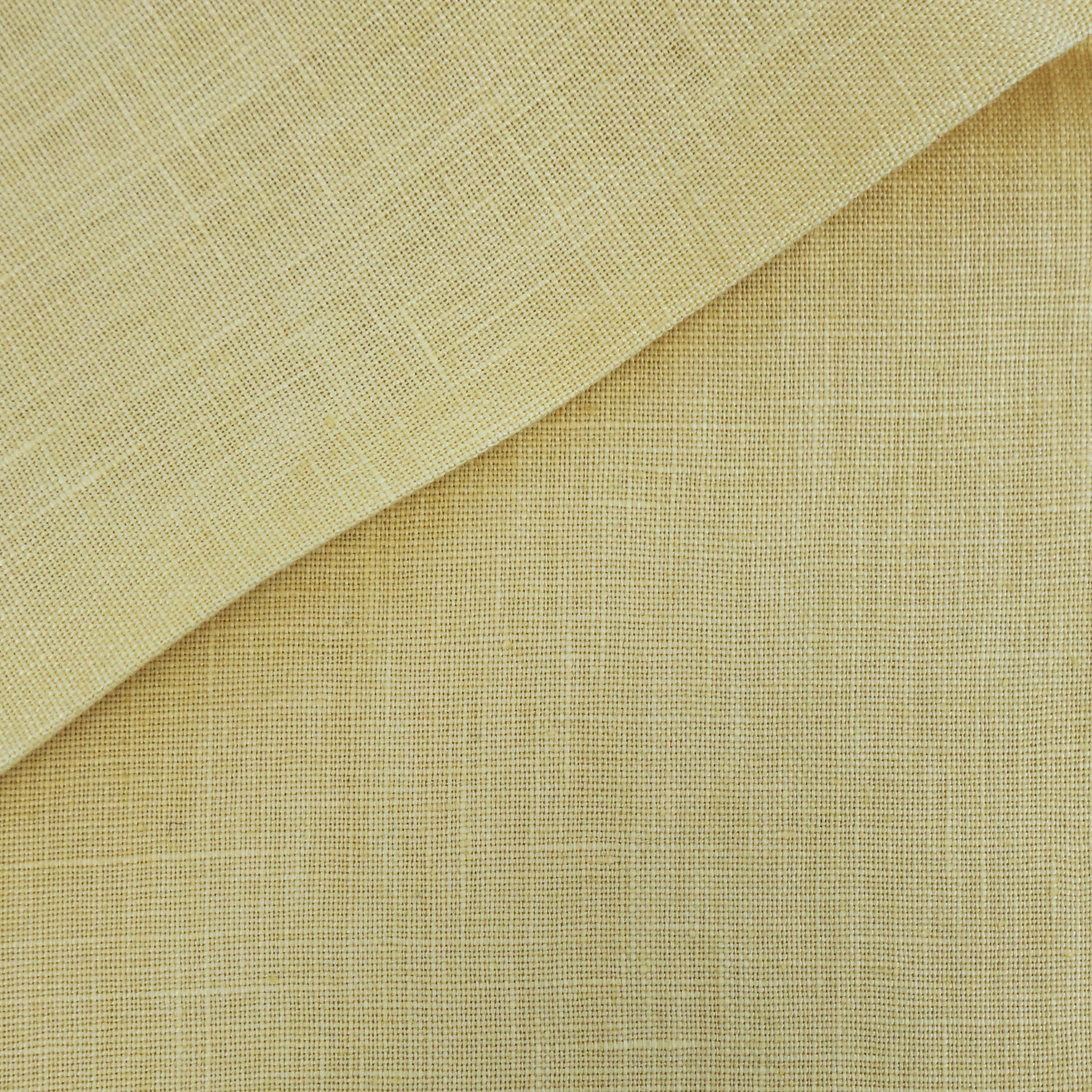 Beige linen-textured fabric with a lighter folded corner and warm natural tones.