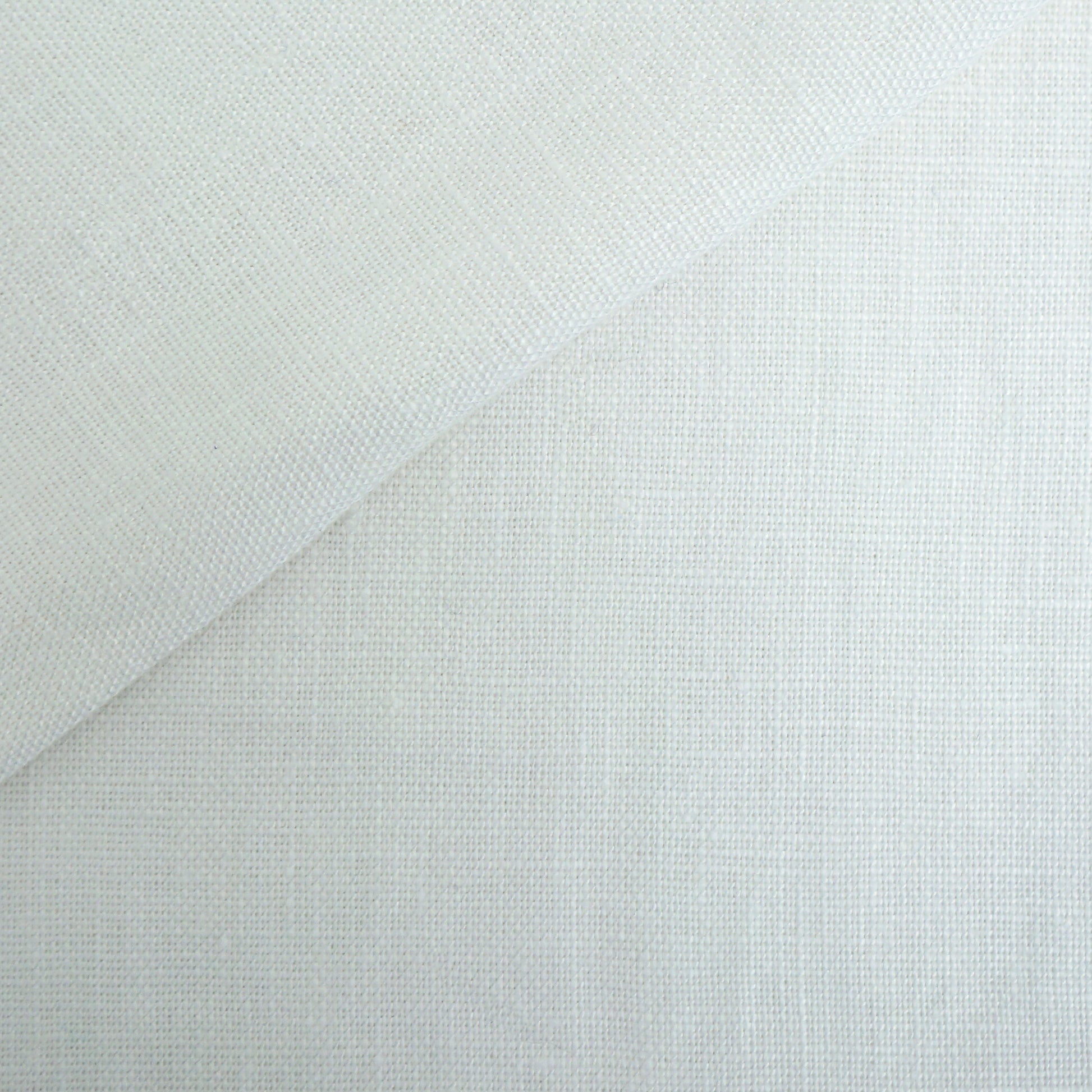 Off-white linen fabric with visible weave and a diagonal fold; versatile textile for drapery or garments.