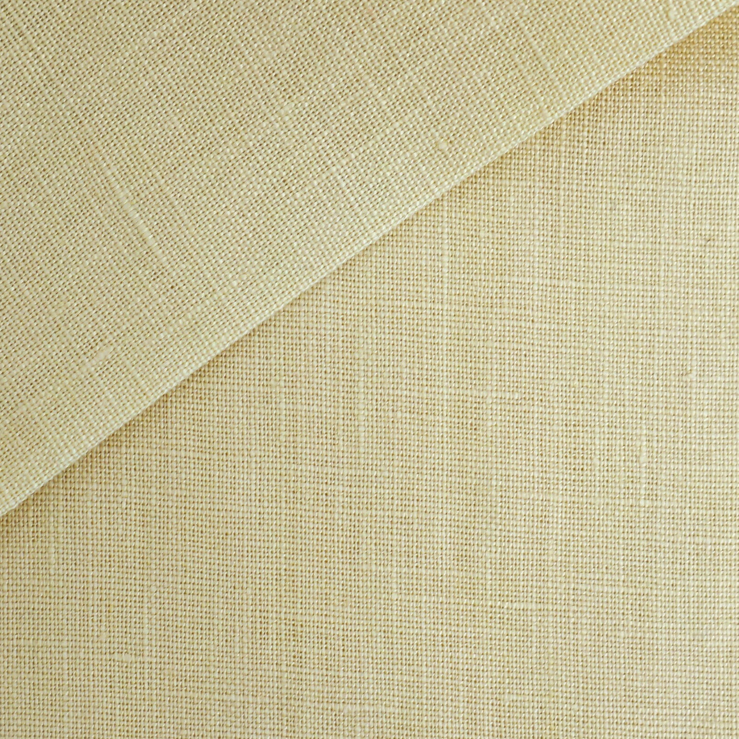 Beige linen fabric with a folded corner, showing a coarse woven texture and natural neutral tone.