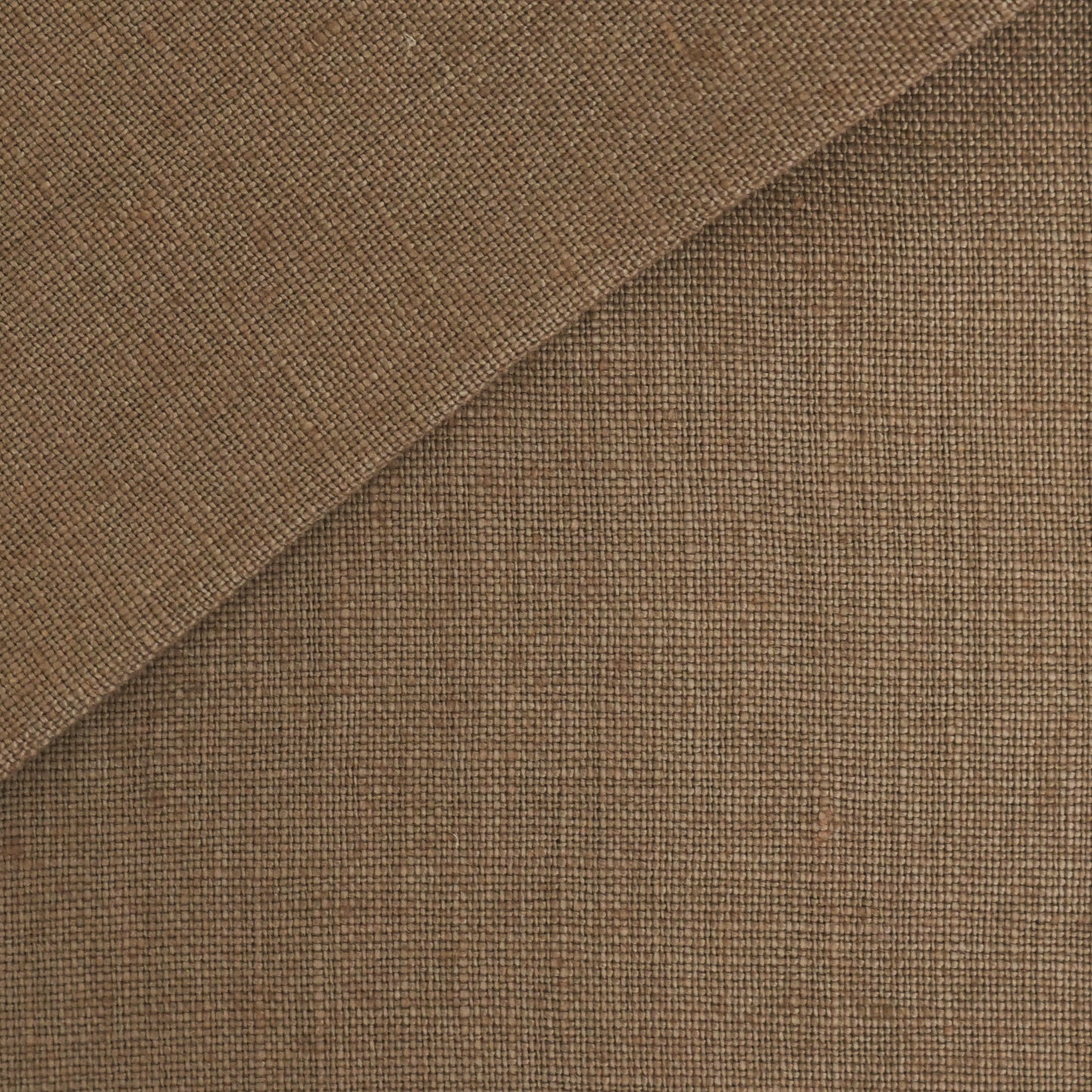 Brown woven linen fabric swatch with diagonal fold, close-up texture.