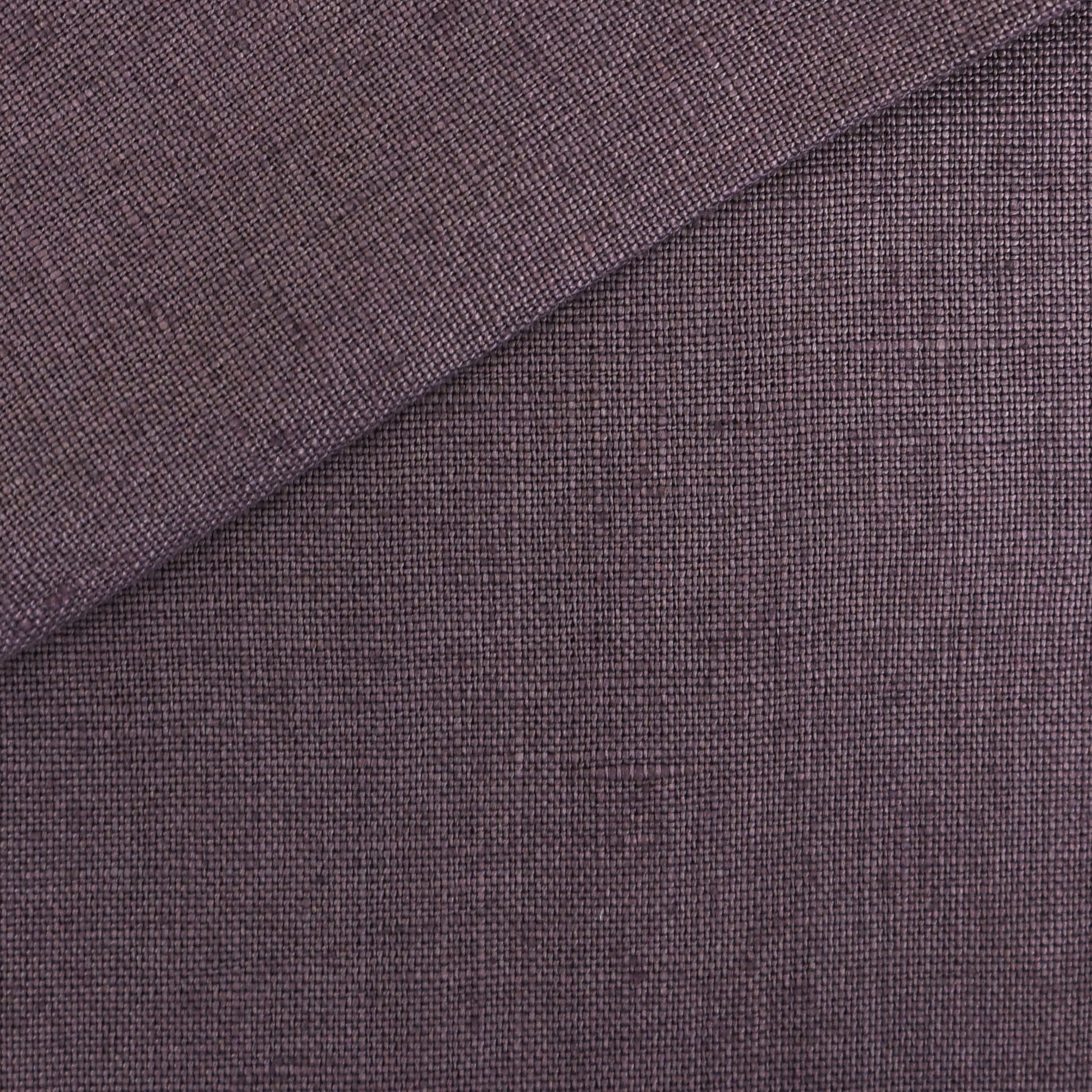 Plum purple woven fabric close-up with folded corner and linen-like texture.