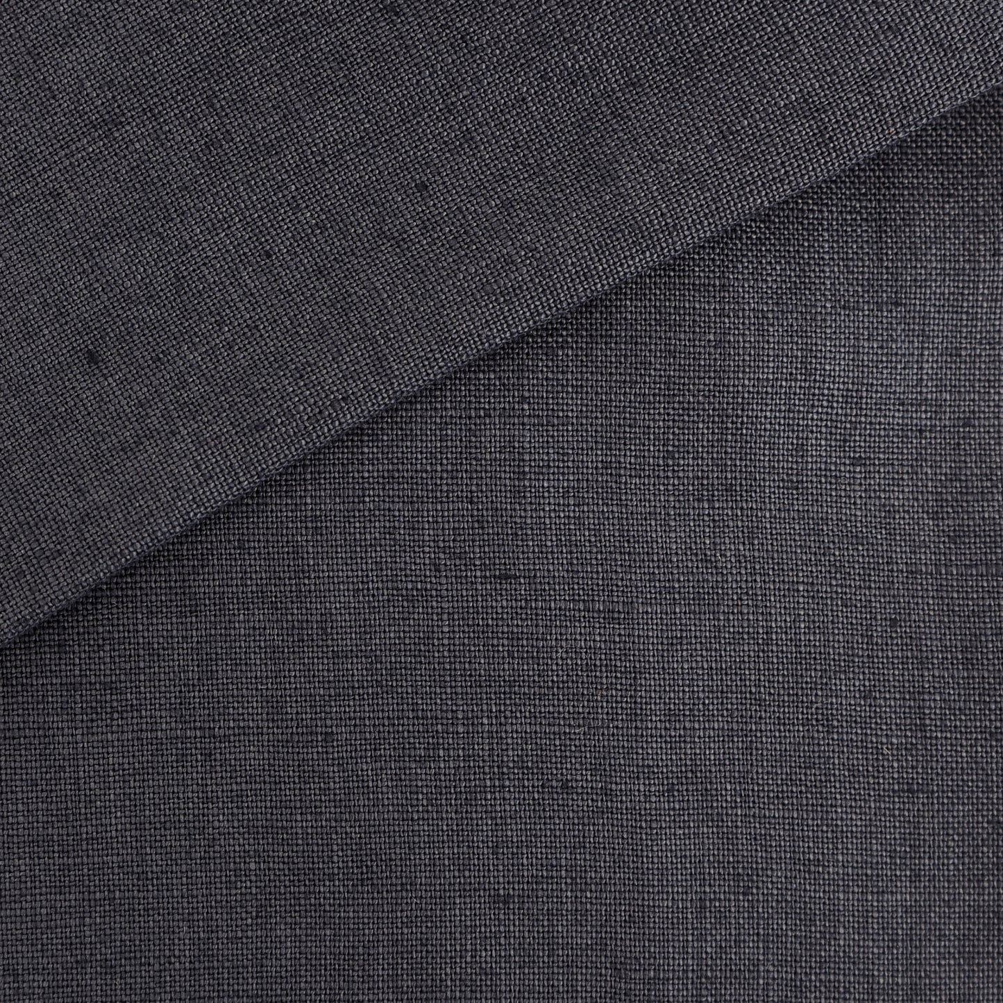 Blue linen fabric with a visible woven texture and a folded corner, suitable for apparel or upholstery.