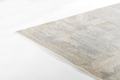Beige and blue geometric woven rug with a soft textured pile; close-up corner view.