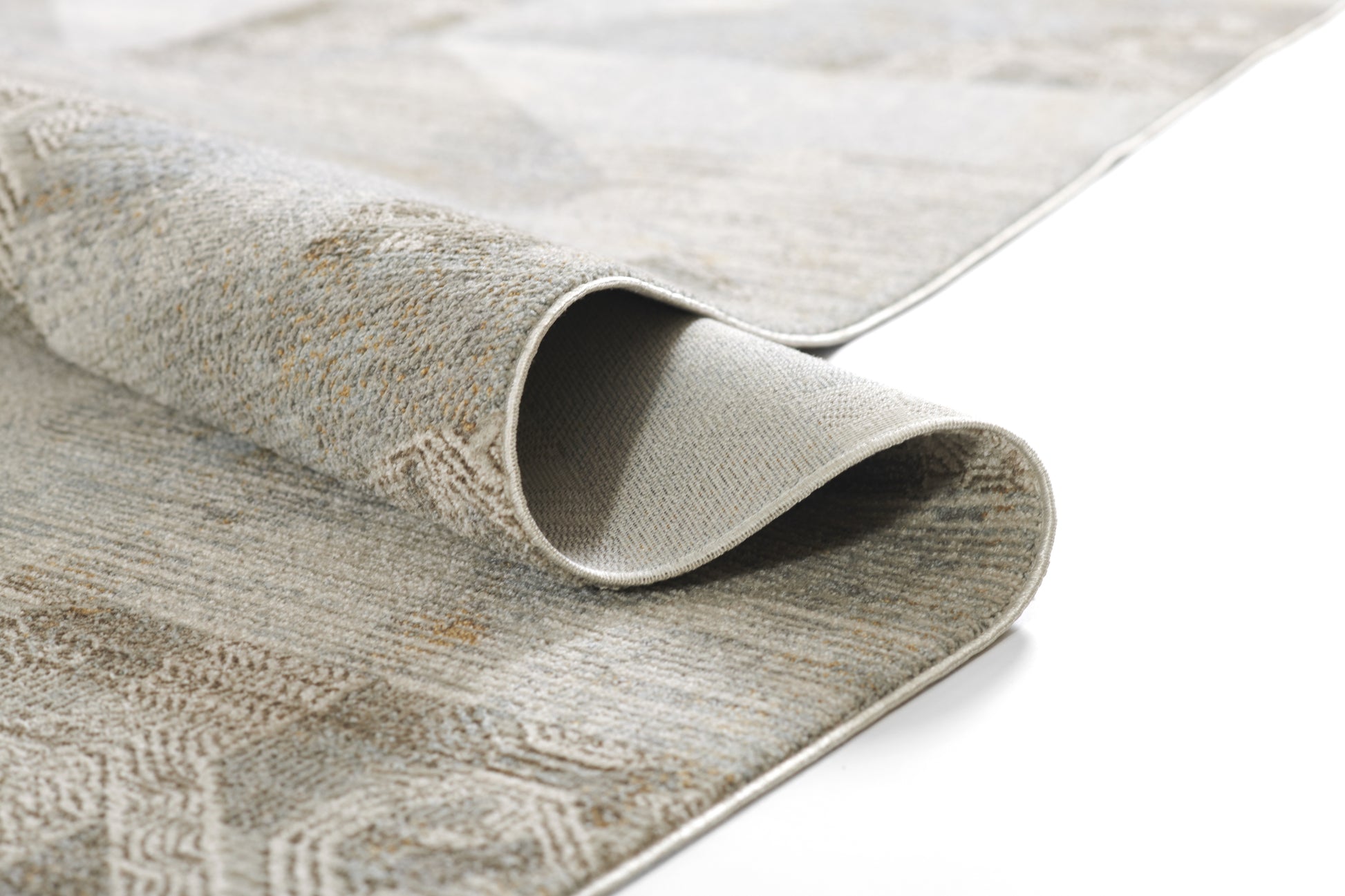 Beige and light-gray geometric woven rug, rolled edge showing the soft underside; neutral area rug for living spaces.