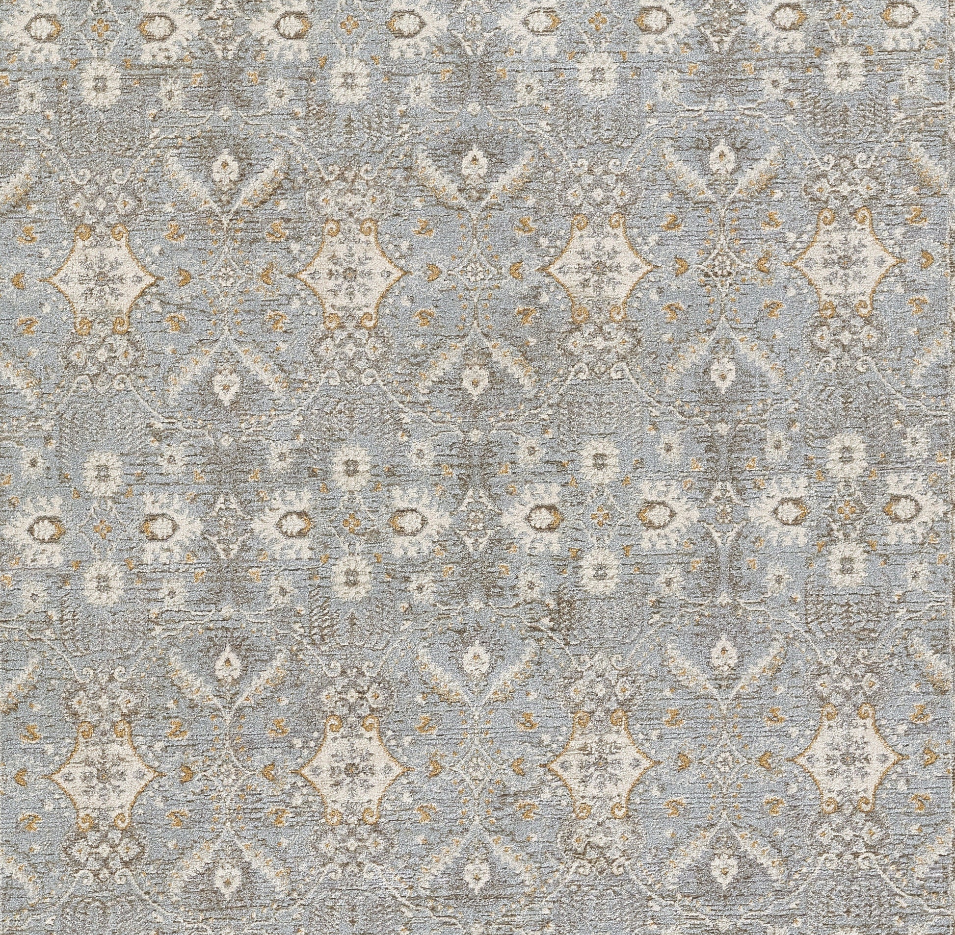 Blue-gray woven area rug with ivory and tan damask motifs in a repeating pattern.