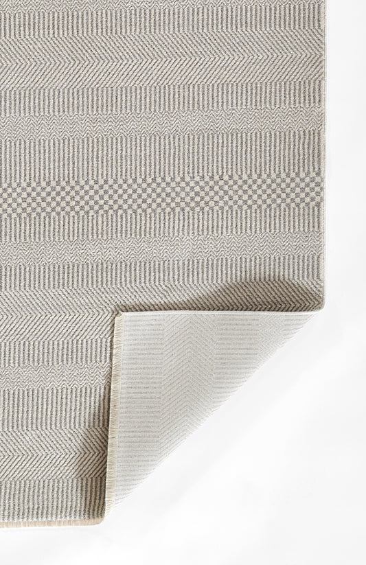 Beige-gray woven rectangular rug with geometric stripe patterns; folded corner reveals light underside.