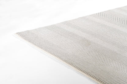 Light gray woven rug with subtle chevron pattern; soft textured fabric, rectangular shape for modern home decor.