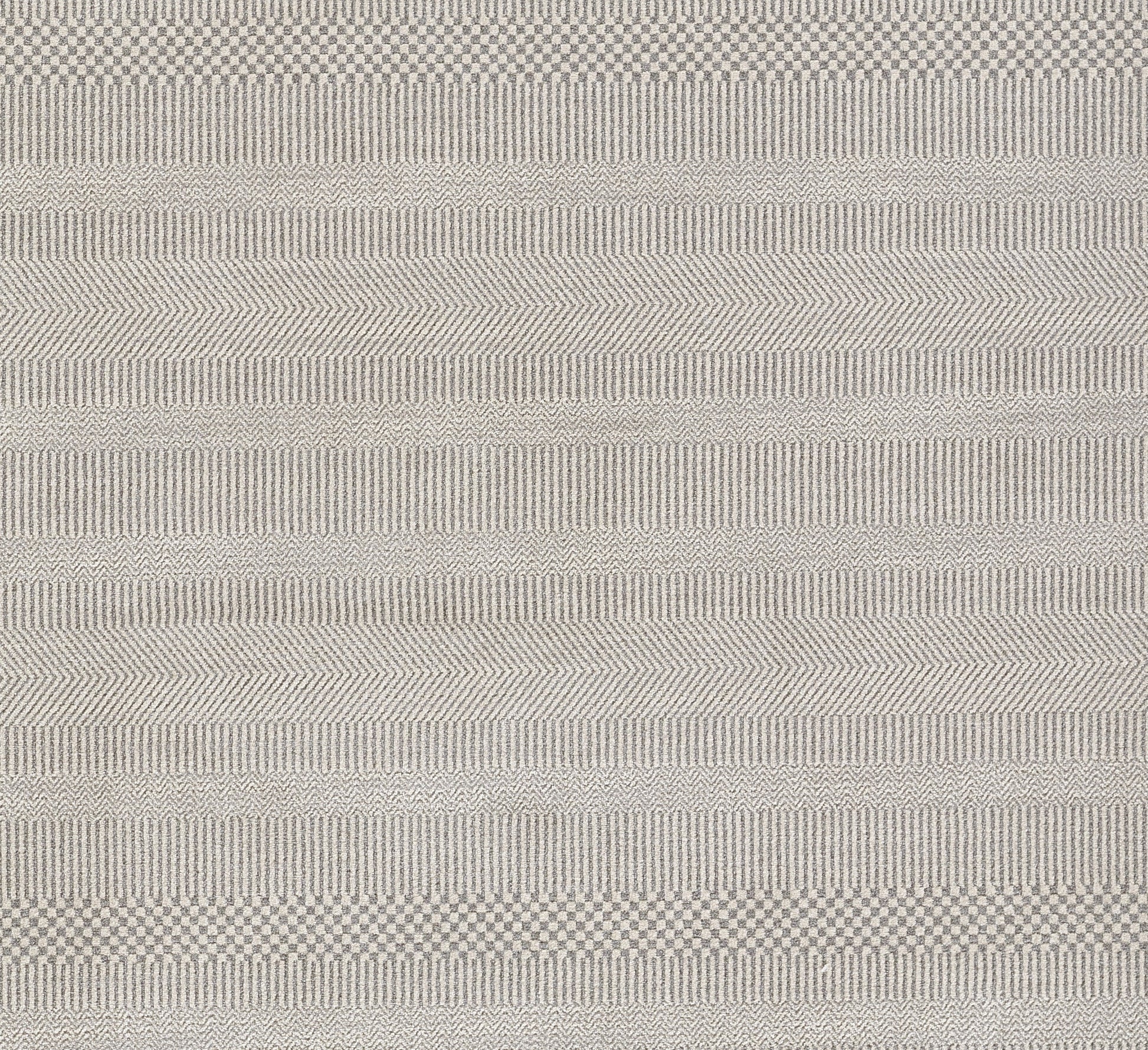 Light gray woven rug with varied stripe textures and subtle chevrons.