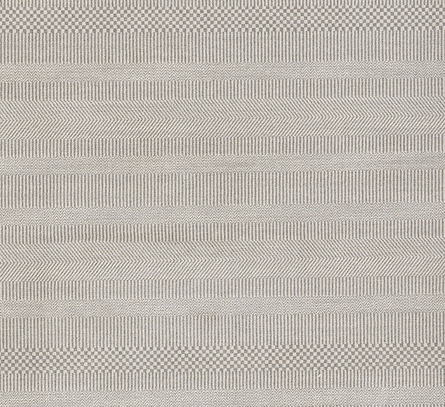 Gray woven rug with subtle chevron and stripe patterns; textured, versatile floor covering.