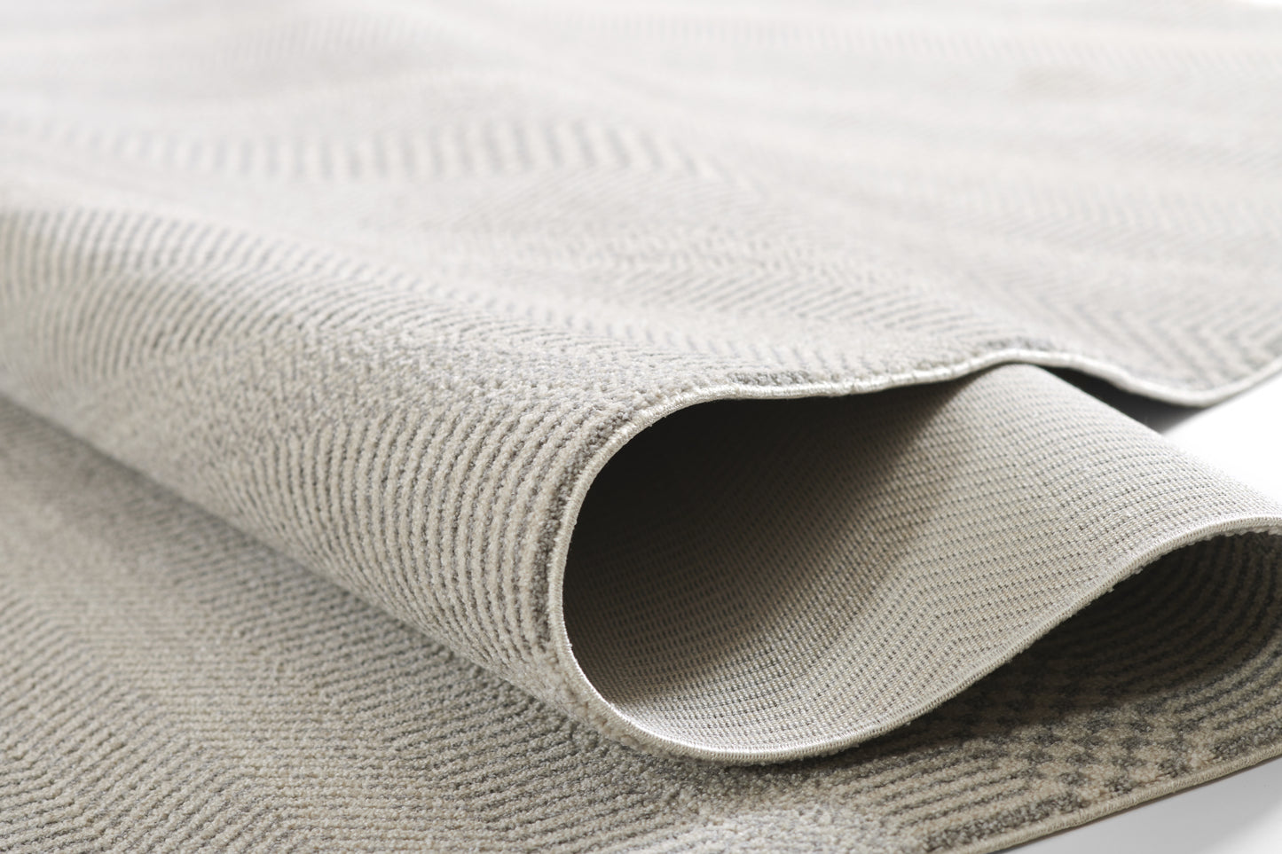 Light gray textured wool-blend rug with a subtle weave and soft drape, shown folded; 2' x 4'.