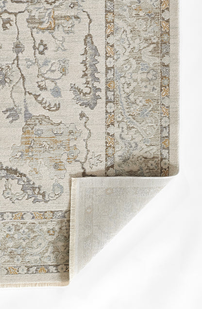 Light beige-gray oriental rug with floral motif and ornate border; subtle blue and gold accents, folded corner.