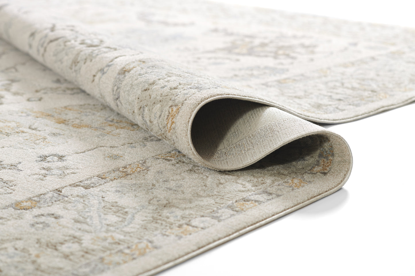 Light beige flatwoven rug with blue-gray patterns, rolled edge showing soft underside.
