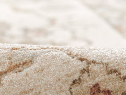 Beige textured rug close-up with cream & tan fibers and a soft plush pile.