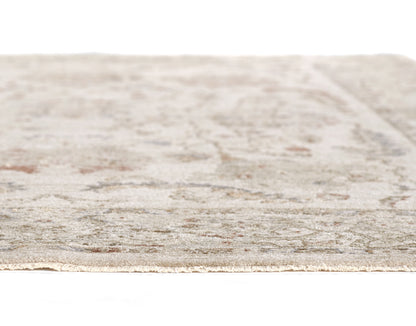 Beige-gray patterned rug with subtle distressed motif; close-up edge view, woven texture.