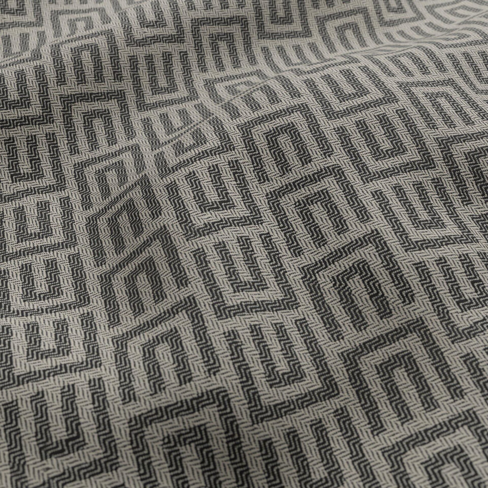 Black and white geometric jacquard outdoor fabric with a Greek key maze pattern.