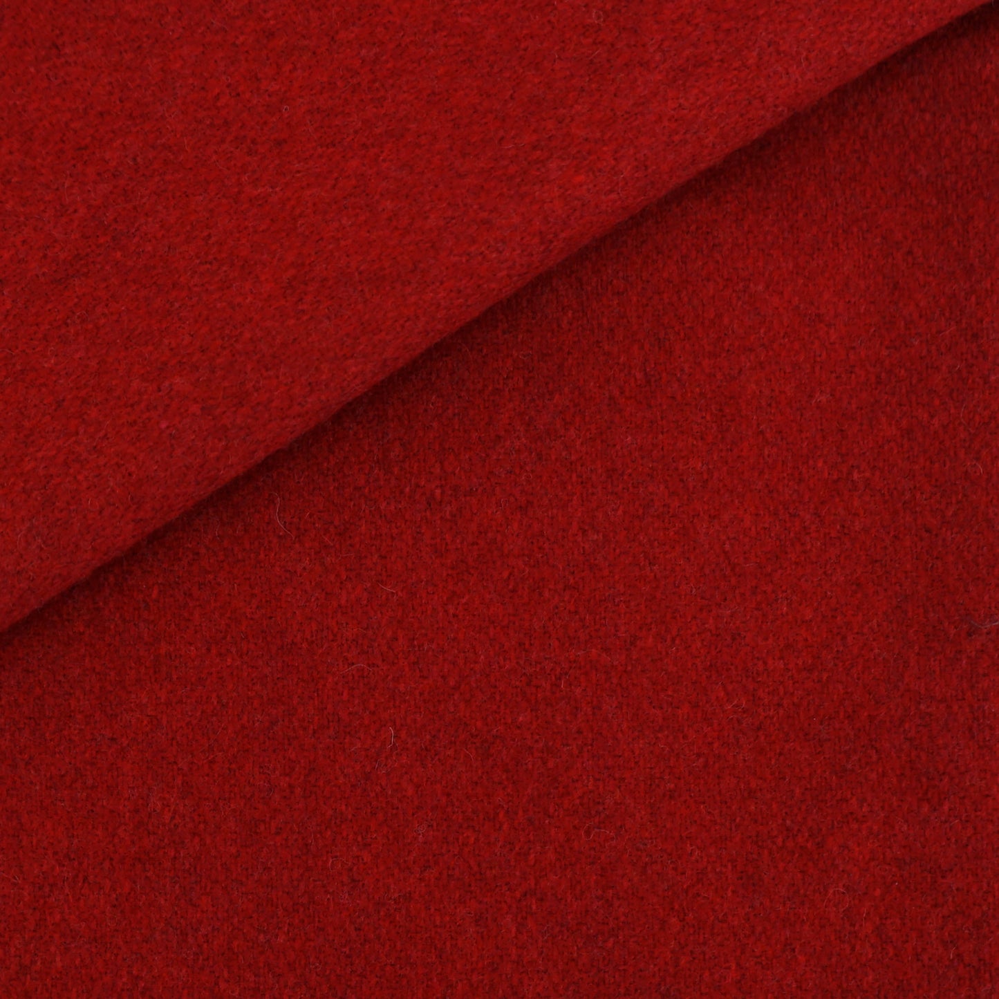 Deep red wool-like fabric with a diagonal fold; plush, soft texture.