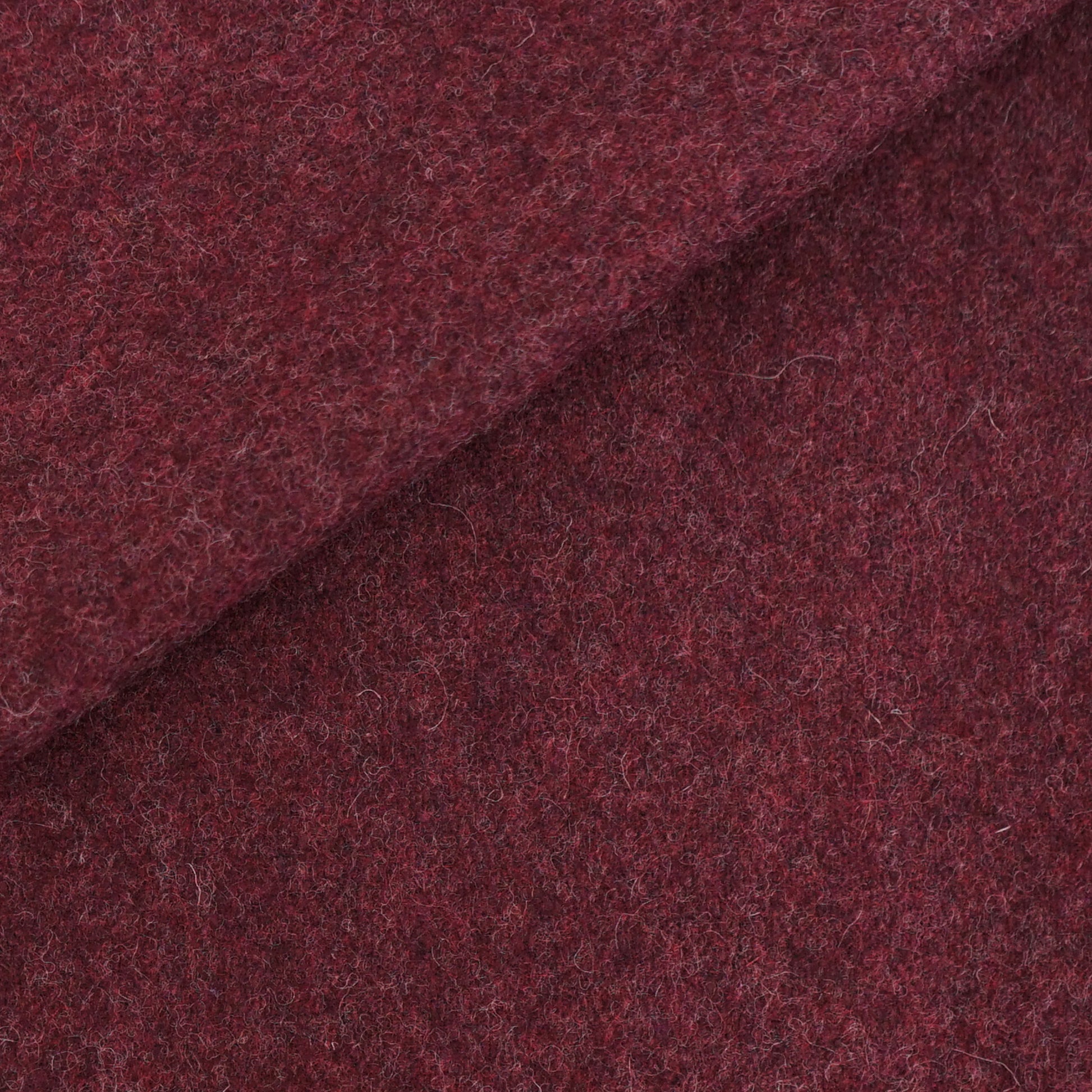 Deep burgundy wool fabric with fuzzy texture and a diagonal fold.