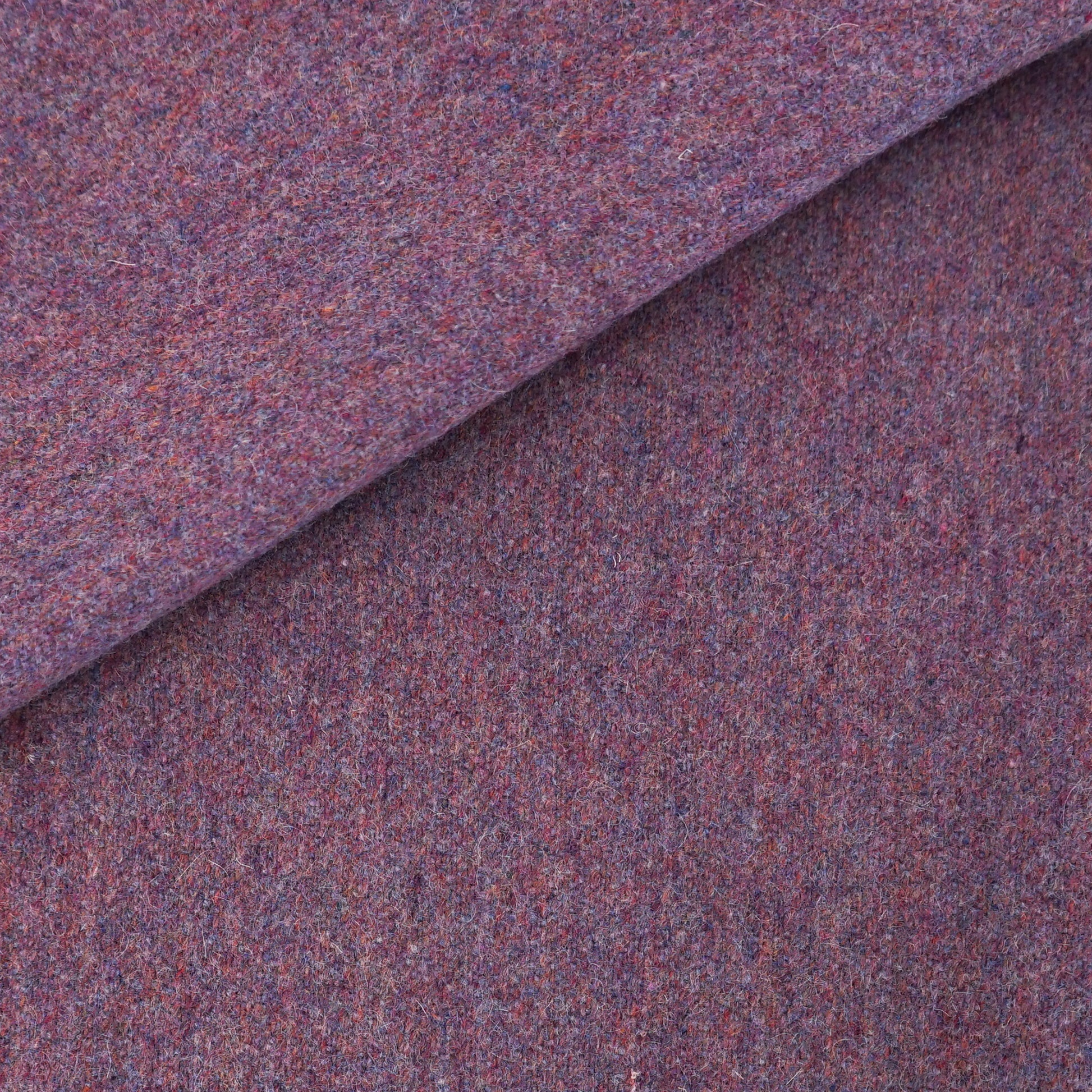 Purple heathered wool fabric, folded at the top corner; cozy tweed textile.