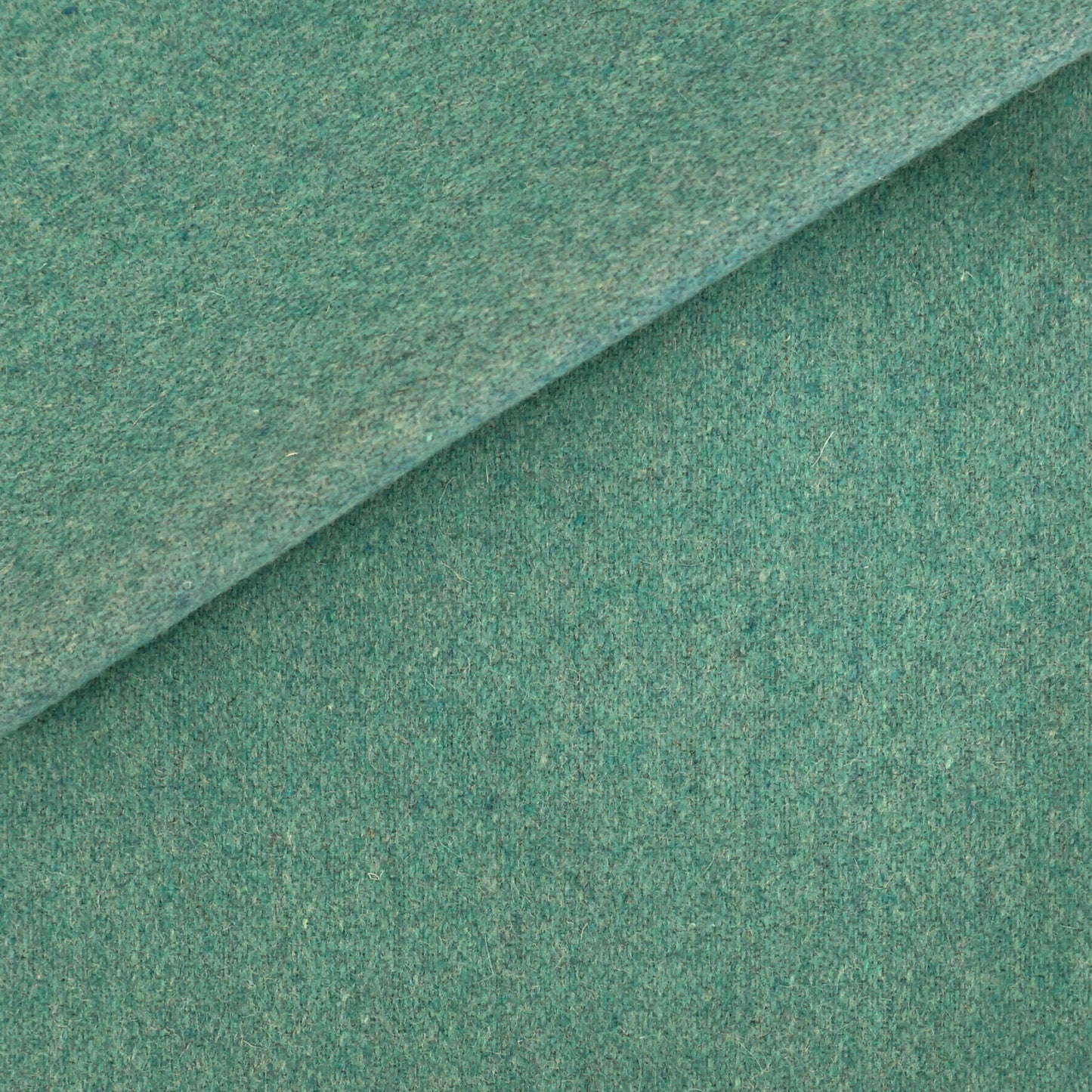 Blue wool fabric with a diagonal fold, soft texture and visible fibers.