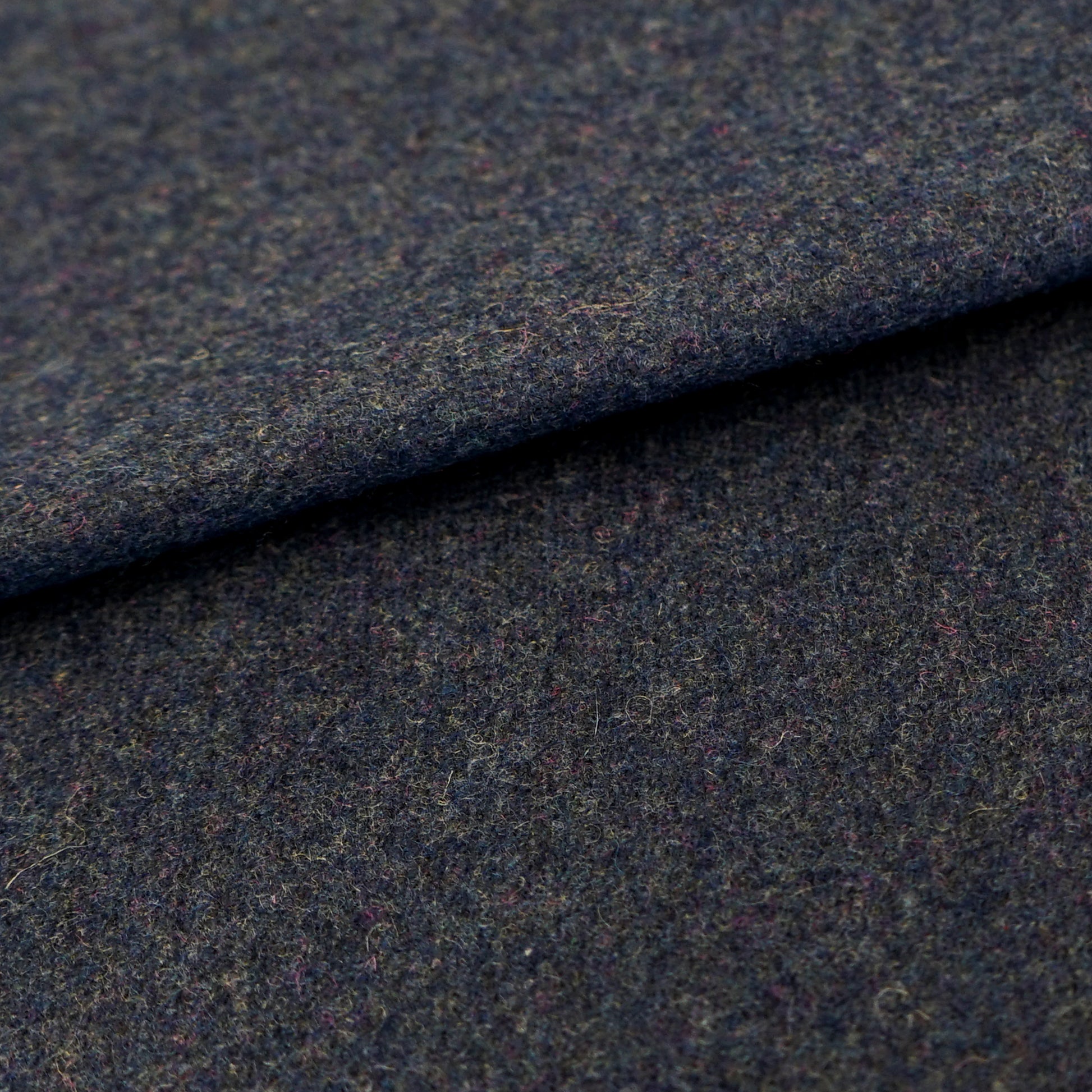 Dark blue wool fabric with a plain texture; close-up fold shows woven texture.