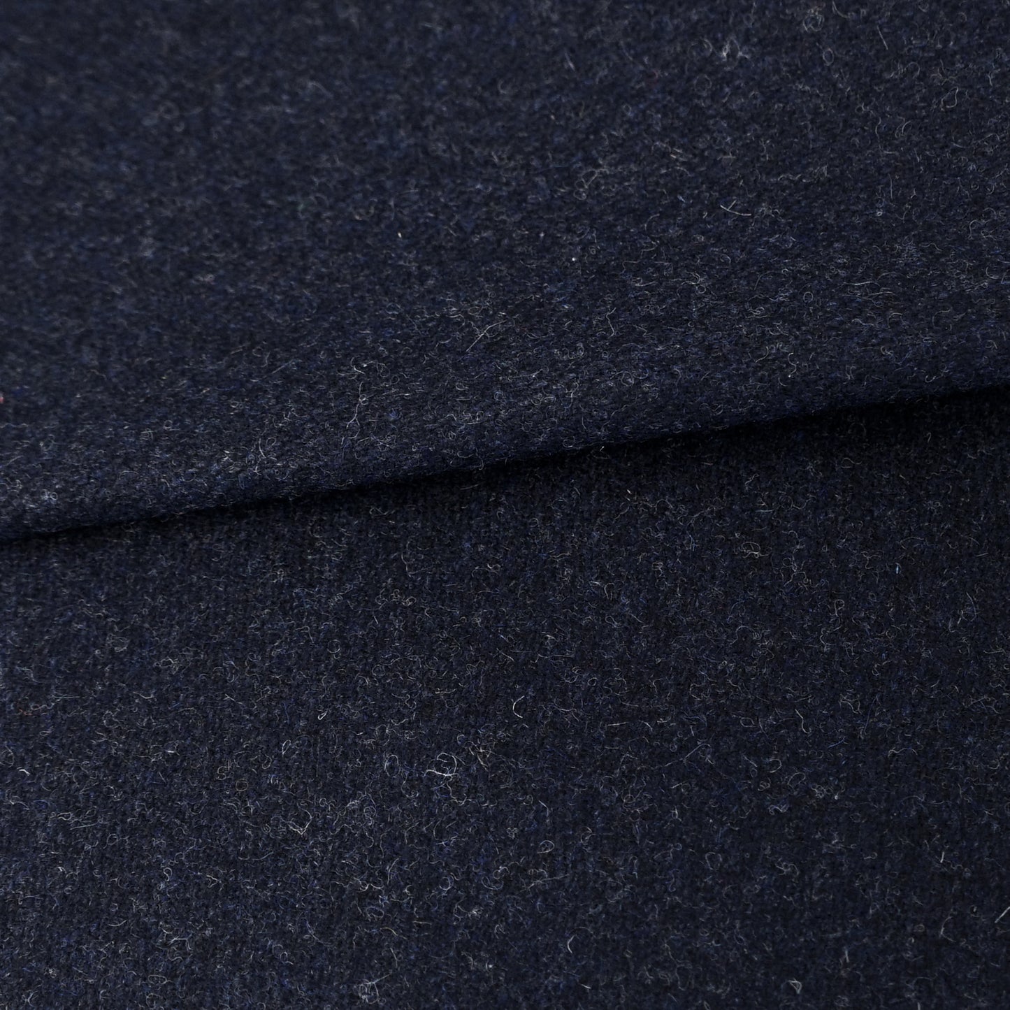 Dark navy wool fabric with a soft brushed texture, folded; ideal for coats and jackets.