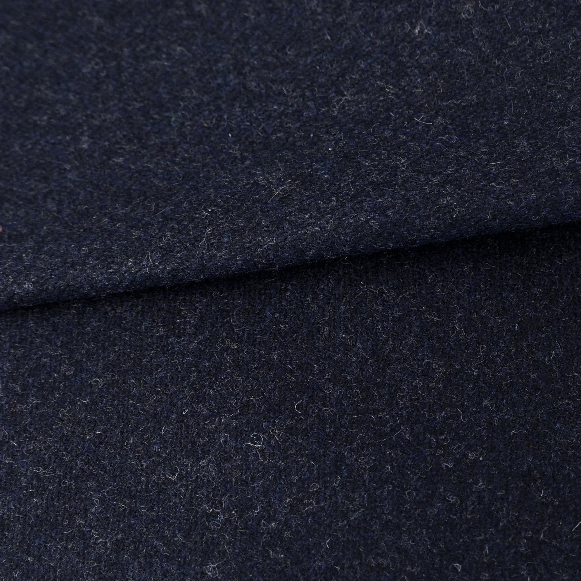 Dark navy wool fabric with a soft brushed texture, folded; ideal for coats and jackets.
