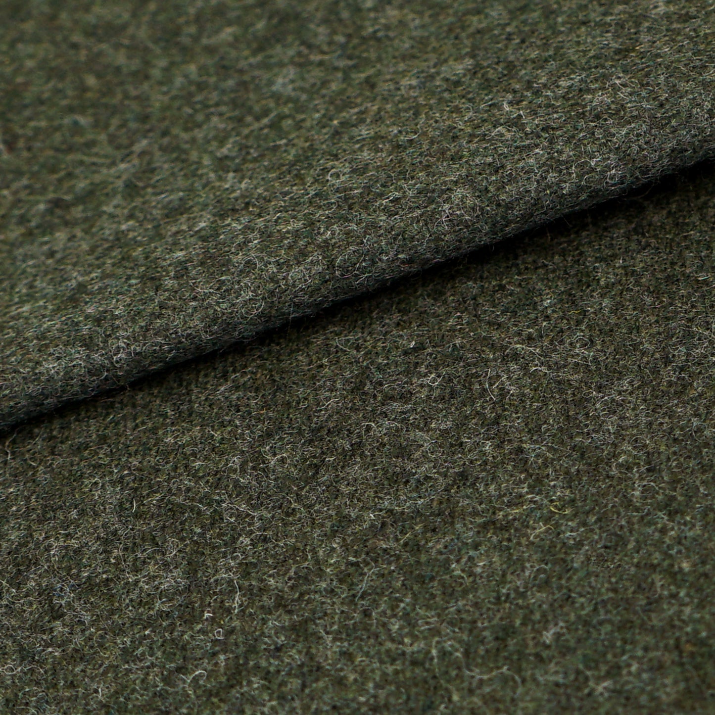 Dark olive-green wool fabric with a fuzzy texture and a folded edge; suitable for coats, jackets, or upholstery.