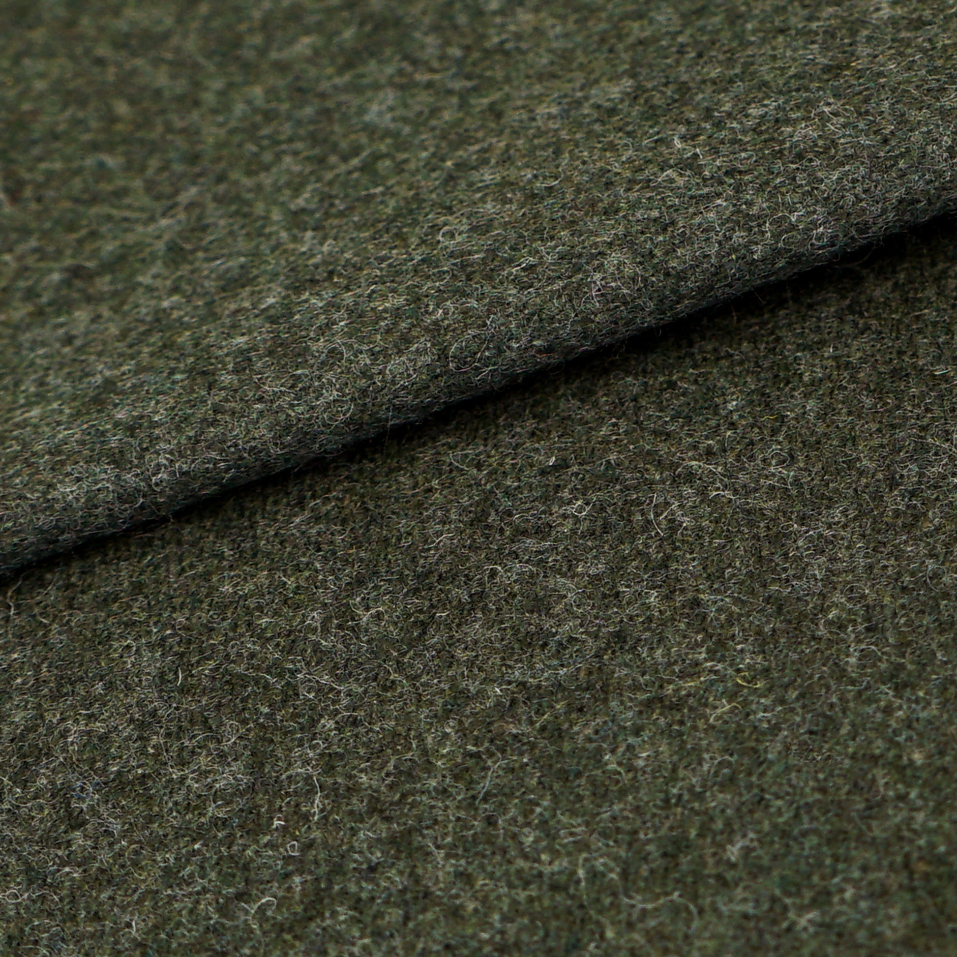 Dark olive-green wool fabric with a fuzzy texture and a folded edge; suitable for coats, jackets, or upholstery.