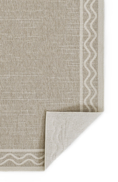 Beige linen‑look textile with white zigzag border along edges; folded corner reveals lighter underside.